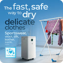 Graphic demonstrating the Safe dry capabilities of the X-95 low energy dehumidifier, while drying clothes inside someone’s home.